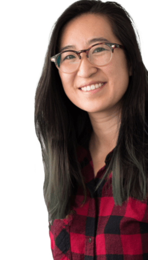 girl in red flannel and glasses smiling 